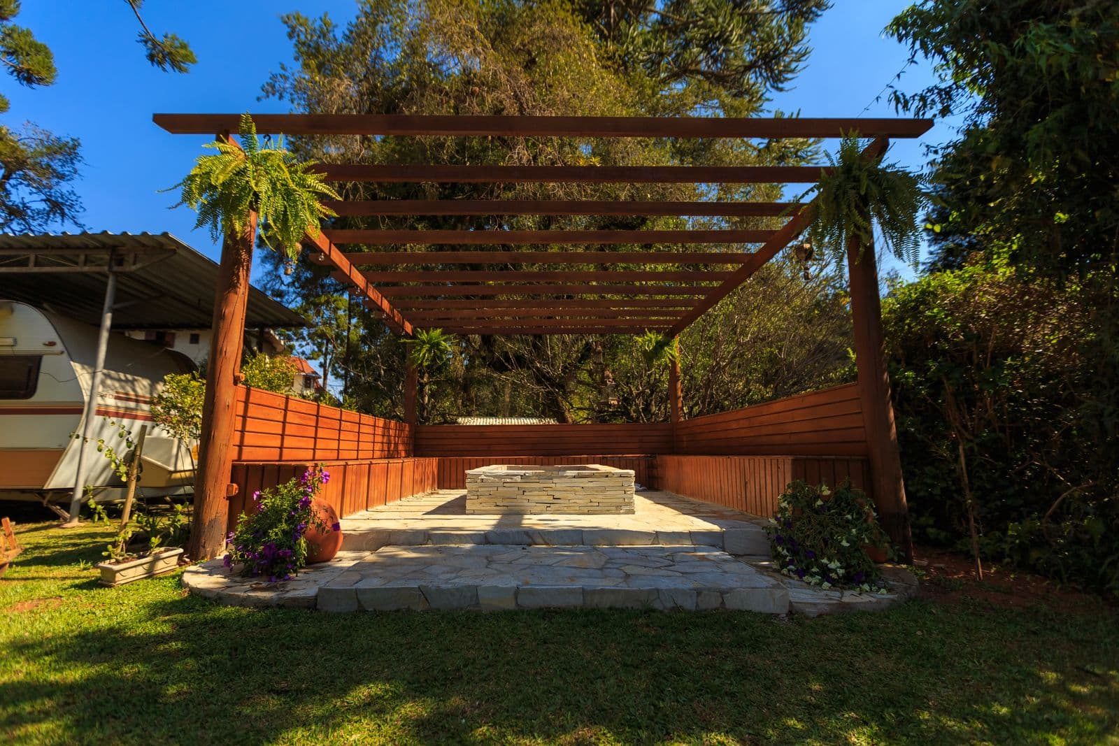 Wooden gazebo in a lush garden setting