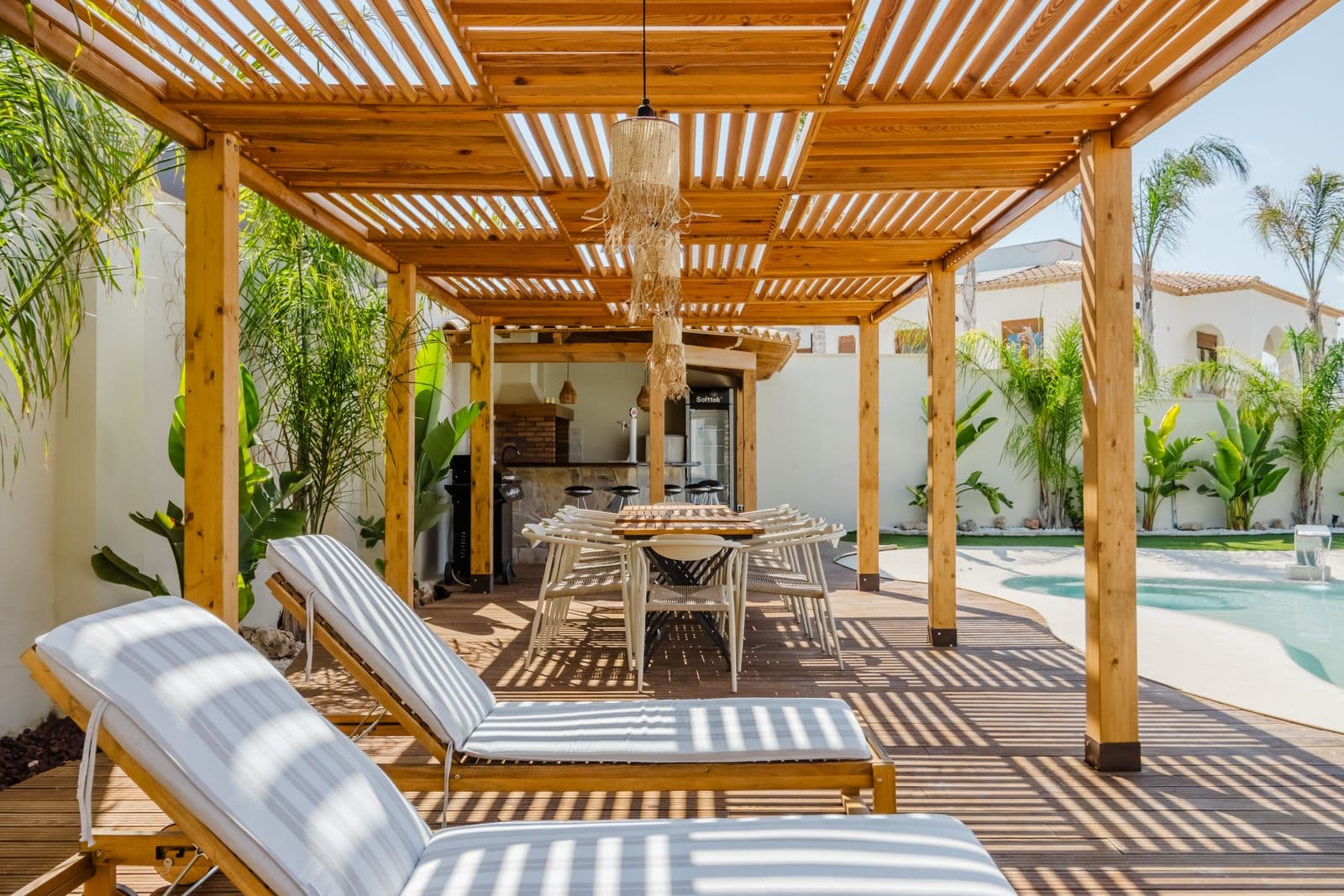 Outdoor patio with wooden pergola and pool