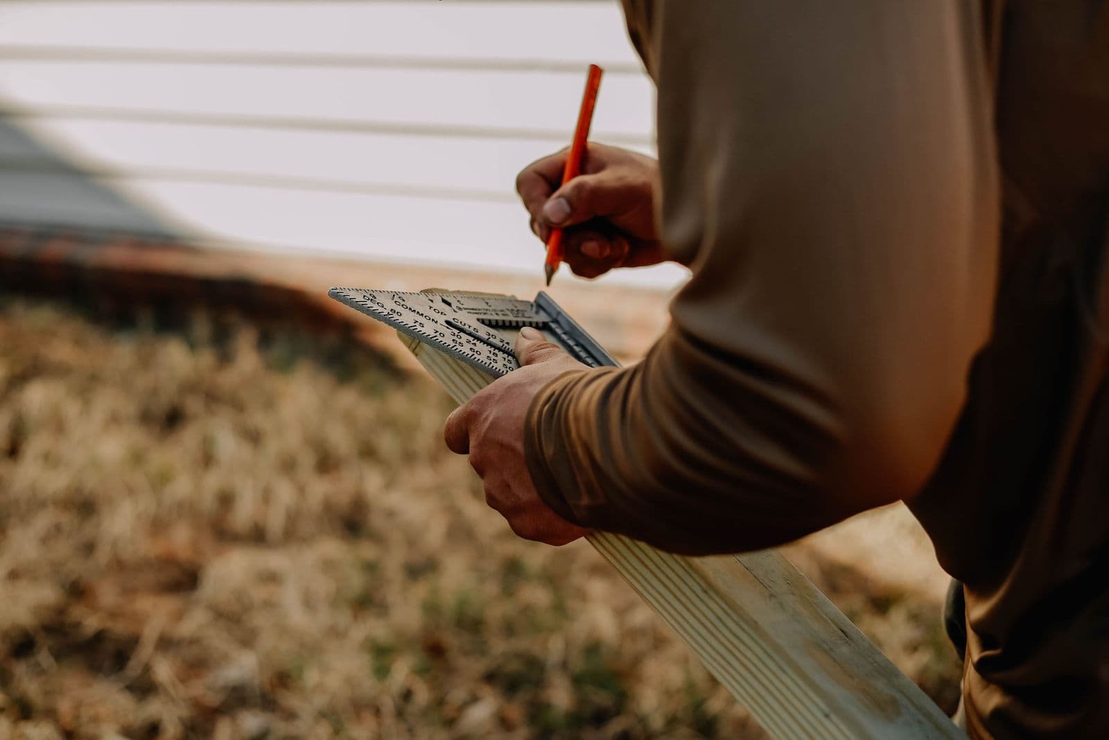 Carpenter measuring wood with precision outdoors